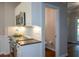 Well-lit kitchen boasts white cabinets, stainless steel microwave, and granite countertops at 1052 Secret Ne Trl, Sugar Hill, GA 30518