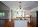 Charming kitchen featuring granite counters, a center island, and stainless steel appliances at 1052 Secret Ne Trl, Sugar Hill, GA 30518