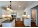 Well-appointed kitchen featuring granite counters, a central island, and stainless steel appliances at 1052 Secret Ne Trl, Sugar Hill, GA 30518
