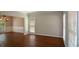 Bright living room featuring hardwood floors, neutral walls, and large windows at 1052 Secret Ne Trl, Sugar Hill, GA 30518