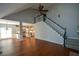 Open-concept living room connects to the kitchen, and has hardwood floors and a staircase at 1052 Secret Ne Trl, Sugar Hill, GA 30518