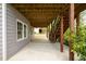 Covered patio features wooden beams, stairs to the upper deck, and access to the backyard, perfect for outdoor gatherings at 1052 Secret Ne Trl, Sugar Hill, GA 30518