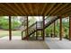 Spacious covered patio with staircase provides an ideal space for outdoor entertaining or relaxing in the shade at 1052 Secret Ne Trl, Sugar Hill, GA 30518