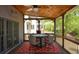 Charming screened porch with outdoor furniture and a ceiling fan provides a cozy space to enjoy the surrounding views at 1052 Secret Ne Trl, Sugar Hill, GA 30518