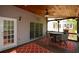 Relaxing screened-in porch with a wood ceiling, ceiling fan, and outdoor seating, perfect for enjoying the outdoors at 1052 Secret Ne Trl, Sugar Hill, GA 30518