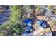 Aerial view of a brick home with a well-maintained lawn in a serene, wooded setting at 1081 Talon Trce, Lawrenceville, GA 30043