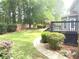 Beautiful backyard with lush greenery, a wooden deck, and a landscaped walkway at 1081 Talon Trce, Lawrenceville, GA 30043
