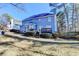 Spacious backyard view of a two-story house with a large wooden deck, perfect for outdoor living at 1081 Talon Trce, Lawrenceville, GA 30043