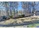 Large backyard with a wooden fence and mature trees at 1081 Talon Trce, Lawrenceville, GA 30043