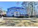 Expansive backyard featuring a deck, lush greenery, and a well-maintained lawn in a serene, wooded setting at 1081 Talon Trce, Lawrenceville, GA 30043