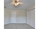 Neutral bedroom featuring a ceiling fan, closet, and ample natural light at 1081 Talon Trce, Lawrenceville, GA 30043