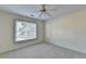 Bedroom with neutral carpet, ceiling fan and a window providing natural light at 1081 Talon Trce, Lawrenceville, GA 30043