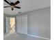 Neutral bedroom featuring a ceiling fan, closet, and entry way to the hall at 1081 Talon Trce, Lawrenceville, GA 30043