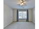 Bright bedroom with a ceiling fan and a large window overlooking the neighborhood at 1081 Talon Trce, Lawrenceville, GA 30043