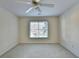 Carpeted bedroom features a ceiling fan and a window at 1081 Talon Trce, Lawrenceville, GA 30043