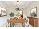 Elegant dining room with decorative chandelier, seating for six, and decorative wall art at 1081 Talon Trce, Lawrenceville, GA 30043