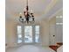 Bay window dining area with decorative chandelier and backyard views at 1081 Talon Trce, Lawrenceville, GA 30043