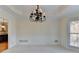 Formal dining room featuring wainscoting, a tray ceiling, and an elegant chandelier at 1081 Talon Trce, Lawrenceville, GA 30043