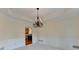 Formal dining room showcasing decorative chandelier, tray ceiling, and elegant wainscoting at 1081 Talon Trce, Lawrenceville, GA 30043