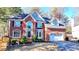 Stately two-story brick home with a manicured lawn and attached two car garage at 1081 Talon Trce, Lawrenceville, GA 30043