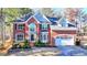 Stately two-story brick home with a manicured lawn and attached two car garage at 1081 Talon Trce, Lawrenceville, GA 30043