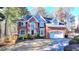 Charming two-story brick home with a well-maintained lawn and two car garage at 1081 Talon Trce, Lawrenceville, GA 30043