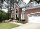 Beautiful brick home with attached garage, arched window and landscaped front yard at 1081 Talon Trce, Lawrenceville, GA 30043