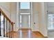 Bright foyer with hardwood floors, soaring ceilings, and staircase with metal balusters at 1081 Talon Trce, Lawrenceville, GA 30043