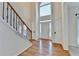 Bright foyer with hardwood floors, a staircase, and a view of the front door at 1081 Talon Trce, Lawrenceville, GA 30043