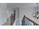 Hallway with wrought iron railing and chandelier at 1081 Talon Trce, Lawrenceville, GA 30043