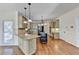Gourmet kitchen featuring granite countertops, stainless appliances, and a large center island at 1081 Talon Trce, Lawrenceville, GA 30043