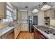 Kitchen featuring stainless steel appliances, granite countertops, and a gas cooktop island at 1081 Talon Trce, Lawrenceville, GA 30043