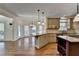 Bright kitchen features a granite-topped island, stainless steel appliances, and hardwood floors at 1081 Talon Trce, Lawrenceville, GA 30043