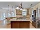 Beautiful kitchen featuring a cooktop island, stainless appliances, and custom cabinetry at 1081 Talon Trce, Lawrenceville, GA 30043