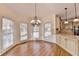 Bright breakfast nook with an elegant chandelier and views from the surrounding windows at 1081 Talon Trce, Lawrenceville, GA 30043