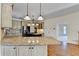 Gourmet kitchen featuring granite countertops, stainless appliances, and a large center island at 1081 Talon Trce, Lawrenceville, GA 30043