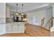 Open kitchen features stainless steel appliances, island with granite countertops, and hardwood floors at 1081 Talon Trce, Lawrenceville, GA 30043
