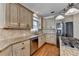 Kitchen featuring stainless steel appliances, granite countertops, and a stylish backsplash at 1081 Talon Trce, Lawrenceville, GA 30043