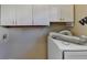 Small laundry room with washer and cabinets at 1081 Talon Trce, Lawrenceville, GA 30043