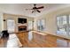Open living room featuring hardwood floors, fireplace and natural light from multiple windows at 1081 Talon Trce, Lawrenceville, GA 30043