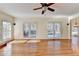 Spacious living room with hardwood floors, large windows, and access to the outdoor deck at 1081 Talon Trce, Lawrenceville, GA 30043