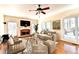 Cozy living room with a brick fireplace, ceiling fan, and comfortable seating arrangement at 1081 Talon Trce, Lawrenceville, GA 30043