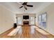 Bright living room featuring hardwood floors, fireplace and natural light from multiple windows at 1081 Talon Trce, Lawrenceville, GA 30043