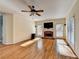 Spacious living room featuring hardwood floors, a brick fireplace, and large windows at 1081 Talon Trce, Lawrenceville, GA 30043
