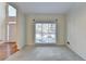 Bright and airy living room featuring large windows, crown molding, and wood floors at 1081 Talon Trce, Lawrenceville, GA 30043