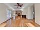 Open-concept living room featuring hardwood floors with kitchen and staircase views at 1081 Talon Trce, Lawrenceville, GA 30043