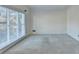 Bright living room with neutral carpet and large window offering ample natural light at 1081 Talon Trce, Lawrenceville, GA 30043