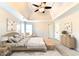 Bright main bedroom featuring neutral tones, decorative ceiling fan, and stylish furnishings at 1081 Talon Trce, Lawrenceville, GA 30043