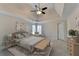 Bright main bedroom featuring neutral tones, decorative ceiling fan, and stylish furnishings at 1081 Talon Trce, Lawrenceville, GA 30043