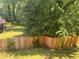 Fenced backyard with a deck, mature trees and grass at 1425 Parkmont Dr, Roswell, GA 30076